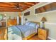 Inviting bedroom with wooden floors, ceiling fan, and access to an ensuite bathroom at 323 Coffee Pot Ne Dr, St Petersburg, FL 33704