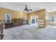 Bedroom under renovation with concrete floor, exposed framing, and ceiling fan at 323 Coffee Pot Ne Dr, St Petersburg, FL 33704
