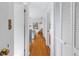Hallway leading to a bedroom with hardwood floors and white closet doors at 323 Coffee Pot Ne Dr, St Petersburg, FL 33704