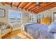 Bright bedroom with ceiling fan, exposed beams, and a picturesque view at 323 Coffee Pot Ne Dr, St Petersburg, FL 33704