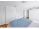 Spacious bedroom with white walls, louvered closet doors, and hardwood floors at 323 Coffee Pot Ne Dr, St Petersburg, FL 33704