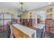 Dining room featuring a wooden table with carved chairs and decorative metal shelving at 323 Coffee Pot Ne Dr, St Petersburg, FL 33704