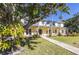 Charming two-story home with lush landscaping and a welcoming walkway at 323 Coffee Pot Ne Dr, St Petersburg, FL 33704