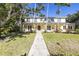 Charming two-story home with a welcoming front entrance and landscaped yard at 323 Coffee Pot Ne Dr, St Petersburg, FL 33704