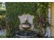 Elegant lion head water fountain with lush greenery adds a touch of charm at 323 Coffee Pot Ne Dr, St Petersburg, FL 33704