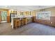 Kitchen with breakfast bar, white cabinets, and ample counter space at 323 Coffee Pot Ne Dr, St Petersburg, FL 33704