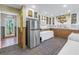 Kitchen featuring white cabinets, a stainless steel refrigerator, and access to the outdoors at 323 Coffee Pot Ne Dr, St Petersburg, FL 33704