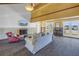 Living area with fireplace, wood beams, white sofa, and French doors at 323 Coffee Pot Ne Dr, St Petersburg, FL 33704