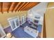 View of the living room from the second floor showcasing high ceilings, wood beams, and abundant light at 323 Coffee Pot Ne Dr, St Petersburg, FL 33704
