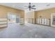 Living room under renovation with concrete floor and exposed framing at 323 Coffee Pot Ne Dr, St Petersburg, FL 33704