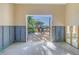 View of patio area with table and chairs from a room under renovation at 323 Coffee Pot Ne Dr, St Petersburg, FL 33704