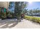 Paved patio area with a table and chairs amidst tropical landscaping at 323 Coffee Pot Ne Dr, St Petersburg, FL 33704