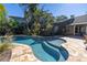 Tranquil pool with a gentle slope entry and ample patio space at 323 Coffee Pot Ne Dr, St Petersburg, FL 33704