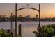 Scenic waterfront view through a decorative gate at sunset at 323 Coffee Pot Ne Dr, St Petersburg, FL 33704
