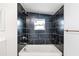 Updated bathroom with dark tile and bathtub at 3458 17Th S Ave, St Petersburg, FL 33711