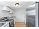 Modern kitchen with stainless steel appliances and light wood flooring at 3458 17Th S Ave, St Petersburg, FL 33711