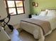Bedroom with double bed, exercise bike, and large window at 3480 Hillmoor Dr, Palm Harbor, FL 34685