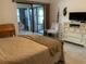 Bedroom with sliding glass doors to screened porch and a dresser at 3480 Hillmoor Dr, Palm Harbor, FL 34685