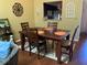 Dining area with hardwood floors and a dark wood table with four chairs at 3480 Hillmoor Dr, Palm Harbor, FL 34685