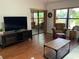 Comfortable living room featuring wood floors and sliding glass doors to the outdoors at 3480 Hillmoor Dr, Palm Harbor, FL 34685