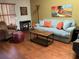 Cozy living room with hardwood floors, a gray sofa, and a comfortable armchair at 3480 Hillmoor Dr, Palm Harbor, FL 34685