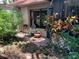 Relaxing patio area surrounded by lush greenery, featuring outdoor seating and a peaceful ambiance at 3480 Hillmoor Dr, Palm Harbor, FL 34685