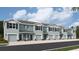 Five-unit townhome building with attached garages and light blue exterior at 4210 Red Banks Ln, Bradenton, FL 34208