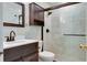 Bathroom with dark vanity, shower, and white tile at 4215 E Bay Dr # 104, Clearwater, FL 33764
