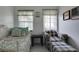 Small bedroom with twin bed and adjacent seating area at 4215 E Bay Dr # 104, Clearwater, FL 33764