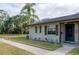 Tan house with brown roof, walkway, and landscaping at 4215 E Bay Dr # 104, Clearwater, FL 33764