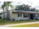 Tan house with brown roof and landscaping at 4215 E Bay Dr # 104, Clearwater, FL 33764