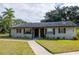 Tan house with brown roof, walkway, and landscaping at 4215 E Bay Dr # 104, Clearwater, FL 33764