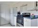 White kitchen with blue countertops and appliances at 4215 E Bay Dr # 104, Clearwater, FL 33764
