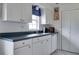 White kitchen with blue countertops and appliances at 4215 E Bay Dr # 104, Clearwater, FL 33764