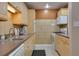 Clean kitchen with light wood cabinets, microwave, and dishwasher at 4215 E Bay Dr # 104, Clearwater, FL 33764