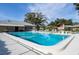 Inviting community pool area with surrounding lounge chairs at 4215 E Bay Dr # 104, Clearwater, FL 33764