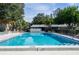 Relaxing community pool with surrounding lounge chairs at 4215 E Bay Dr # 104, Clearwater, FL 33764