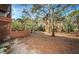 Backyard with trees and wooden fence at 514 Ryans Woods Ln, Palm Harbor, FL 34683