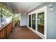 Covered balcony with sliding glass doors and wooden deck flooring at 514 Ryans Woods Ln, Palm Harbor, FL 34683