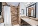Modern bathroom with brown tile shower and vanity with granite countertop at 514 Ryans Woods Ln, Palm Harbor, FL 34683