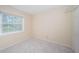 Simple bedroom with carpet, window, and closet at 514 Ryans Woods Ln, Palm Harbor, FL 34683