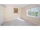 Bright bedroom with carpeted floor and a large window at 514 Ryans Woods Ln, Palm Harbor, FL 34683
