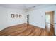 Bright bedroom with hardwood floors and ceiling fan, offering access to a bathroom and hallway at 514 Ryans Woods Ln, Palm Harbor, FL 34683
