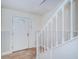 Bright entryway with white staircase and wood flooring at 514 Ryans Woods Ln, Palm Harbor, FL 34683