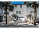 Front view of a gray townhouse with a white door at 514 Ryans Woods Ln, Palm Harbor, FL 34683