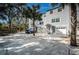 Gray townhouse with a private driveway and palm trees at 514 Ryans Woods Ln, Palm Harbor, FL 34683