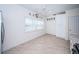 Kitchen area with white cabinets, tile floors and a view to the living room at 514 Ryans Woods Ln, Palm Harbor, FL 34683