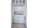Laundry closet with washer and dryer, and overhead cabinets at 514 Ryans Woods Ln, Palm Harbor, FL 34683