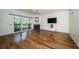 Living room with hardwood floors, fireplace, and sliding doors at 514 Ryans Woods Ln, Palm Harbor, FL 34683