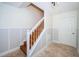 White staircase with wooden steps and a gray wall at 514 Ryans Woods Ln, Palm Harbor, FL 34683